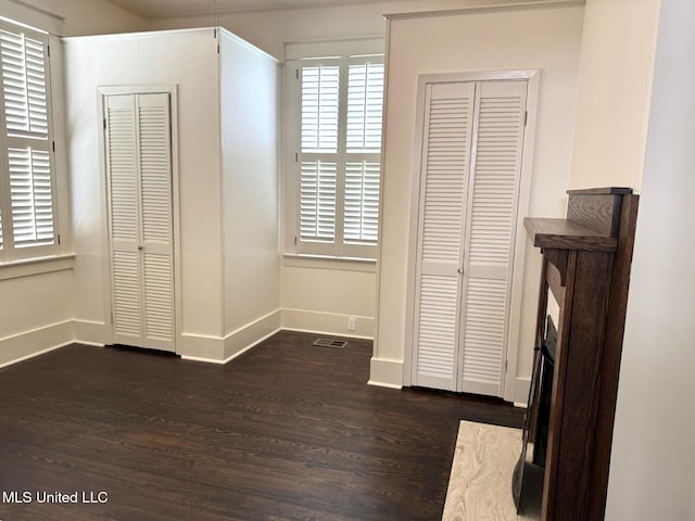 902 Washington St, Natchez, MS 39120 - unfurnished bedroom featuring dark wood-style floors and baseboards