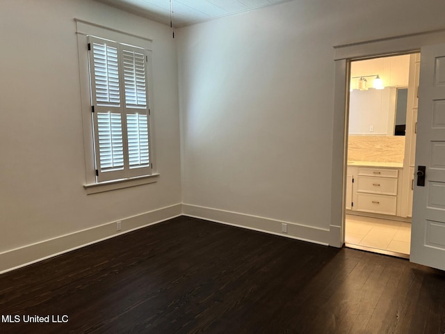 902 Washington St, Natchez, MS 39120 - empty room featuring dark wood finished floors and baseboards