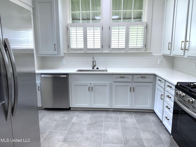 902 Washington St, Natchez, MS 39120 - kitchen with stainless steel appliances, plenty of natural light, tasteful backsplash, and light tile patterned floors