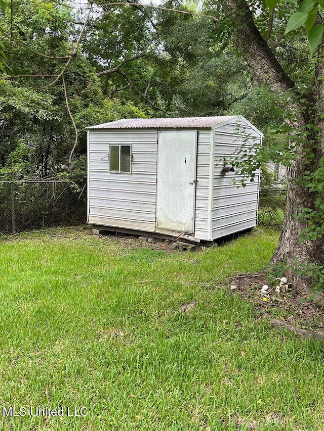 view of outdoor structure featuring a lawn