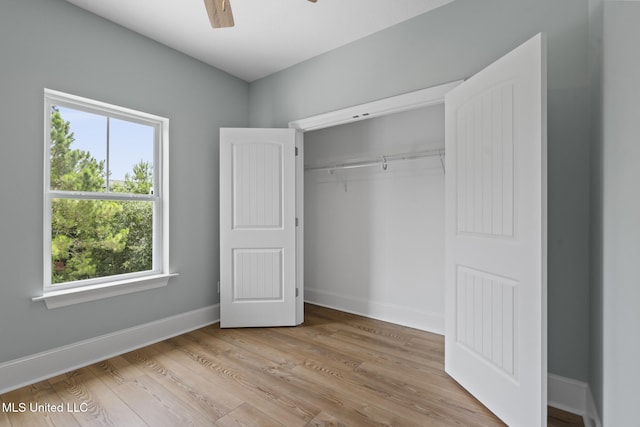 417 4th Ave, Pass Christian, MS 39571 - unfurnished bedroom with light wood-type flooring, a closet, and ceiling fan