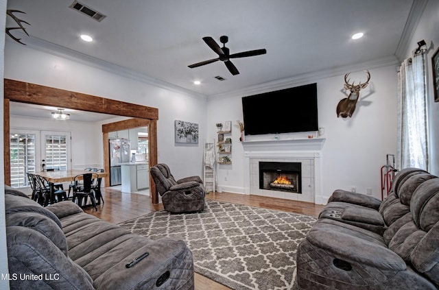 215 Moss Valley Dr, Brandon, MS 39042 - living area featuring light wood-type flooring, ornamental molding, ceiling fan, a tile fireplace, and recessed lighting