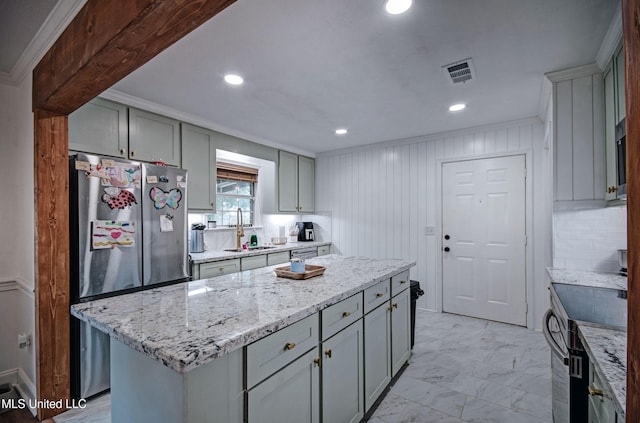 215 Moss Valley Dr, Brandon, MS 39042 - kitchen featuring stainless steel appliances, gray cabinetry, light stone counters, a center island, and crown molding