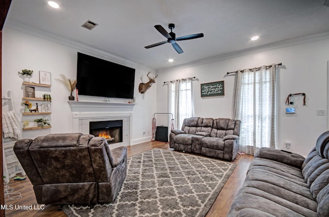 215 Moss Valley Dr, Brandon, MS 39042 - living room with a ceiling fan, a tiled fireplace, wood finished floors, ornamental molding, and recessed lighting