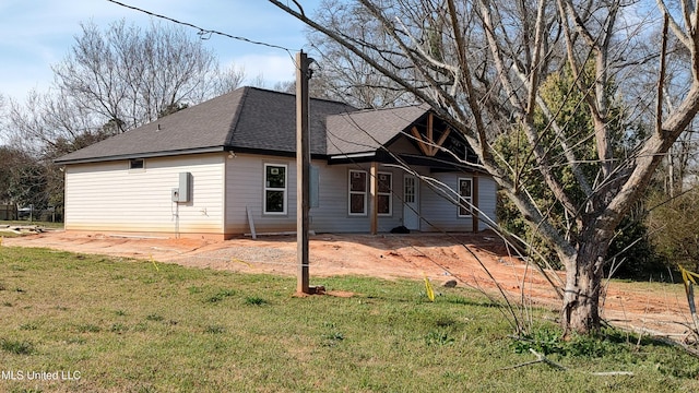 109 N Barnett St, Poplarville, MS 39470 - rear view of house featuring roof with shingles and a yard