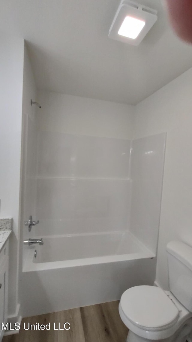 109 N Barnett St, Poplarville, MS 39470 - bathroom featuring toilet, vanity, shower / bath combination, and wood finished floors