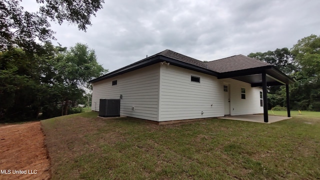 109 N Barnett St, Poplarville, MS 39470 - back of house featuring a patio, central AC unit, a yard, and a shingled roof