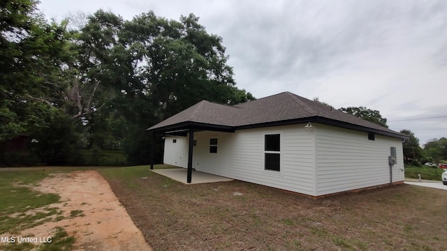 109 N Barnett St, Poplarville, MS 39470 - view of front of house with a patio, a front lawn, and a shingled roof