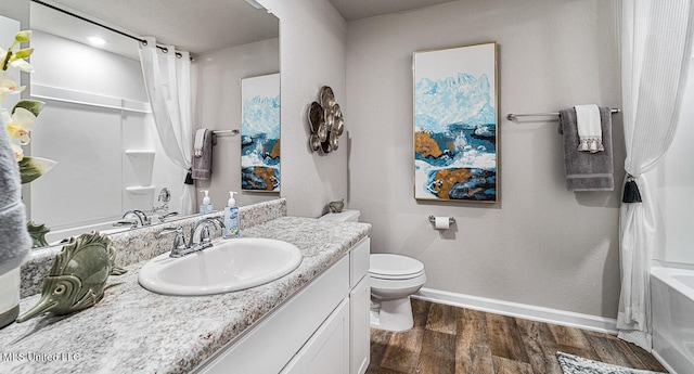 full bathroom with toilet, shower / bathtub combination with curtain, hardwood / wood-style flooring, and vanity