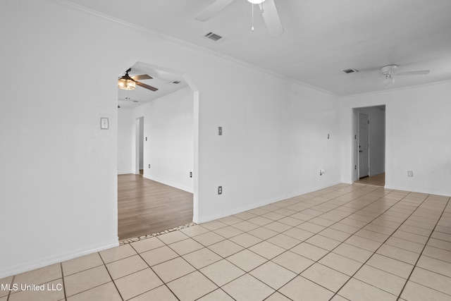 tiled spare room with ceiling fan and crown molding