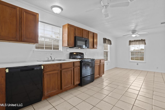 kitchen featuring ceiling fan, black appliances, sink, light tile patterned flooring, and ornamental molding