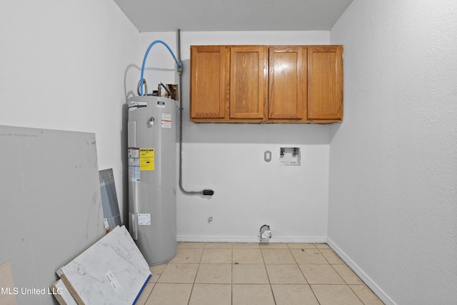 laundry room featuring electric water heater, hookup for a washing machine, light tile patterned floors, hookup for an electric dryer, and cabinets