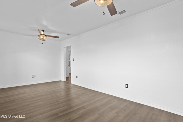 empty room featuring ceiling fan, dark hardwood / wood-style flooring, and ornamental molding