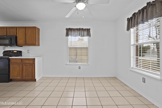 kitchen featuring black appliances, light tile patterned floors, ceiling fan, and ornamental molding