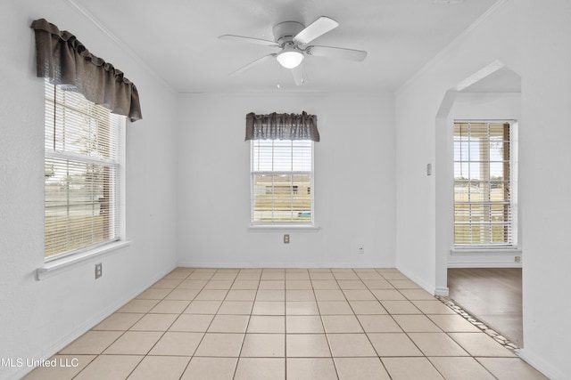 tiled spare room with ceiling fan and crown molding