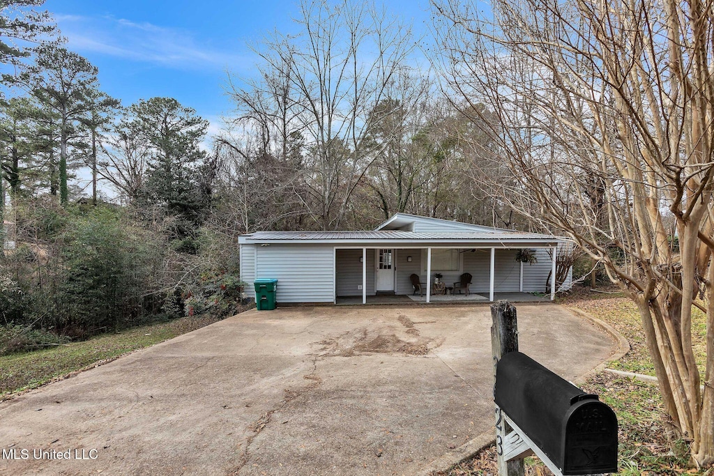 exterior space featuring a carport and covered porch