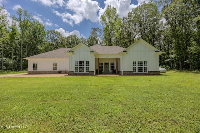 75 Dry Field Cv, Byhalia, MS 38611 - back of property with board and batten siding, a lawn, french doors, and a shingled roof