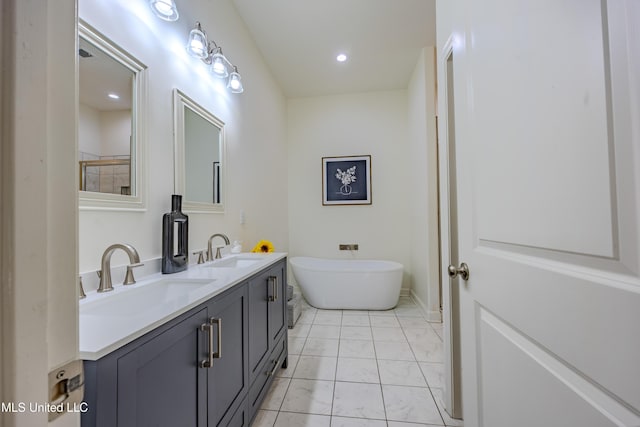75 Dry Field Cv, Byhalia, MS 38611 - full bathroom featuring marble look tile flooring, double vanity, a freestanding bath, and recessed lighting