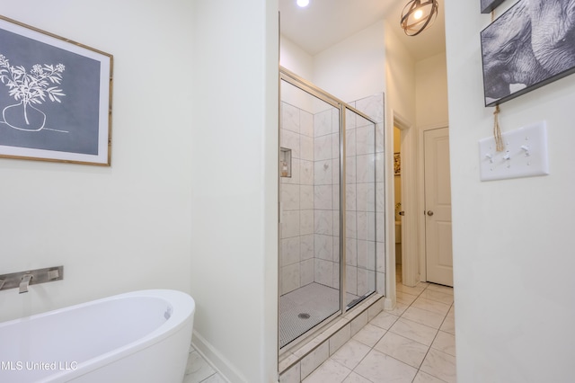 75 Dry Field Cv, Byhalia, MS 38611 - bathroom featuring a shower stall, a freestanding tub, and marble look tile flooring