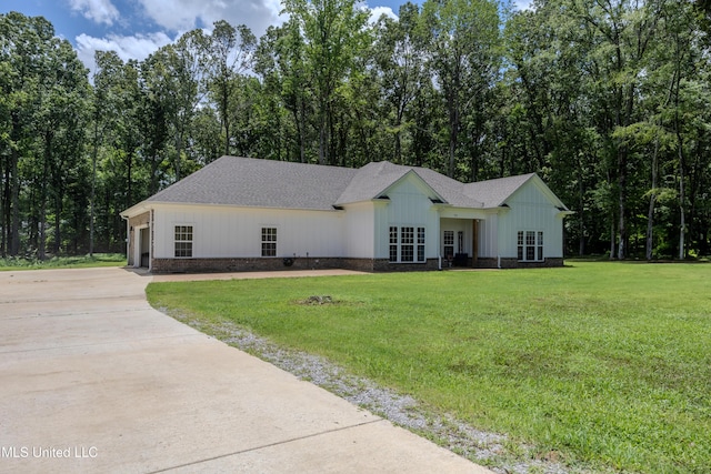 75 Dry Field Cv, Byhalia, MS 38611 - view of front of property with concrete driveway, a front yard, roof with shingles, board and batten siding, and a garage