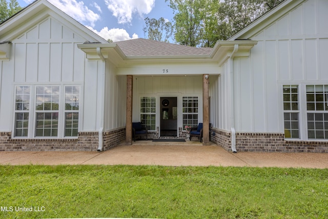 75 Dry Field Cv, Byhalia, MS 38611 - property entrance with board and batten siding, a shingled roof, and a lawn