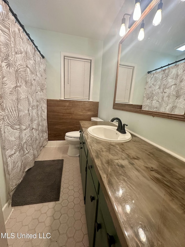 bathroom featuring vanity, tile patterned flooring, and toilet