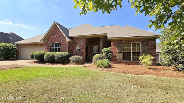 ranch-style home featuring a front lawn and a garage