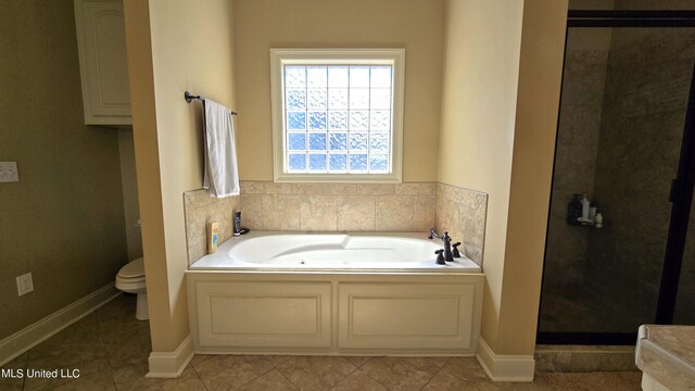 bathroom featuring toilet, plus walk in shower, and tile patterned flooring