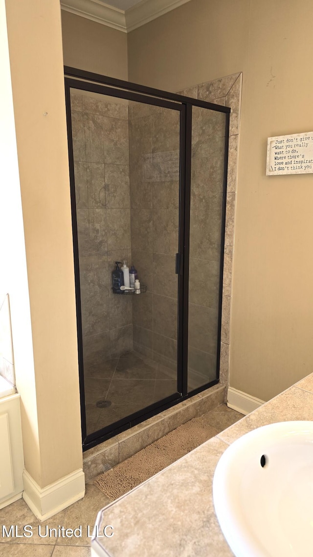 bathroom with vanity, ornamental molding, walk in shower, and tile patterned flooring