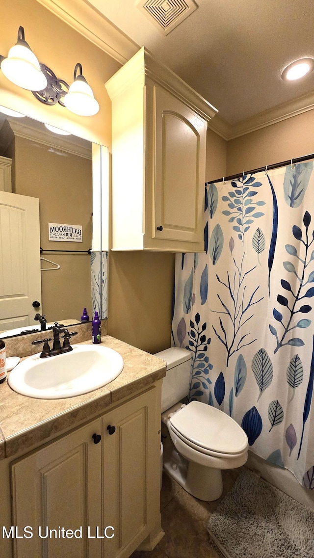 bathroom featuring toilet, crown molding, and vanity