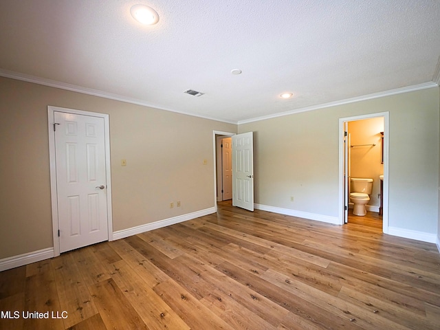 unfurnished bedroom featuring ornamental molding, baseboards, light wood-type flooring, connected bathroom, and recessed lighting