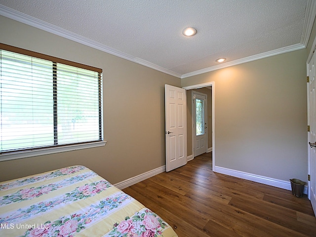 bedroom featuring baseboards, a textured ceiling, dark wood-style flooring, ornamental molding, and recessed lighting