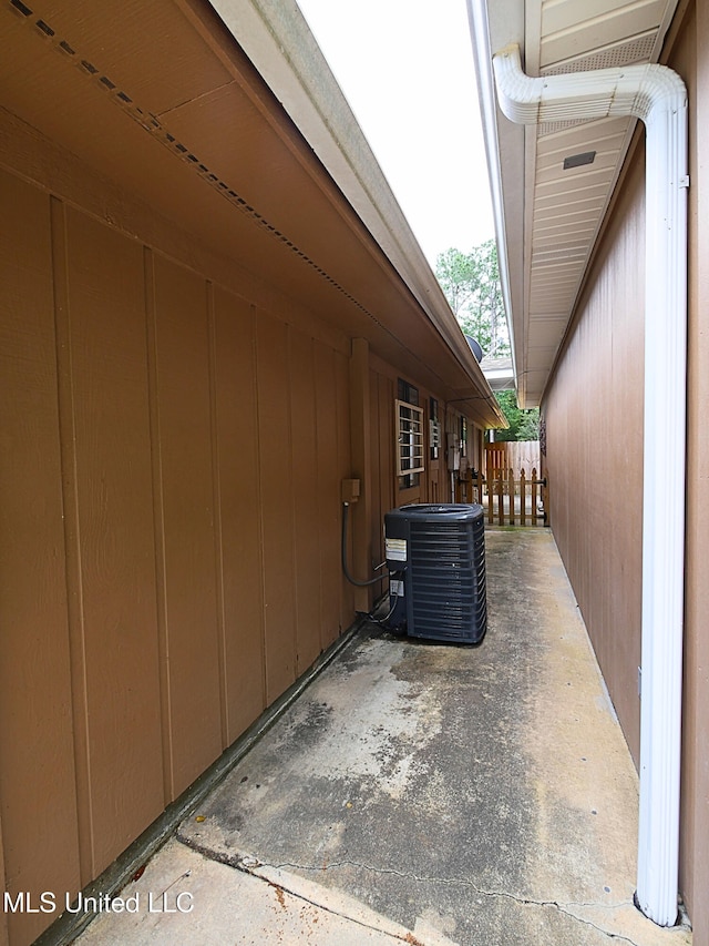 view of side of property with central air condition unit, a patio area, and fence