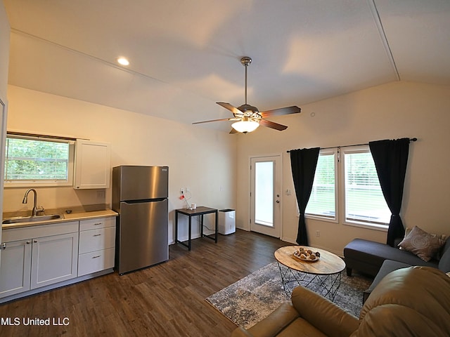 living room with vaulted ceiling, dark wood finished floors, and a ceiling fan