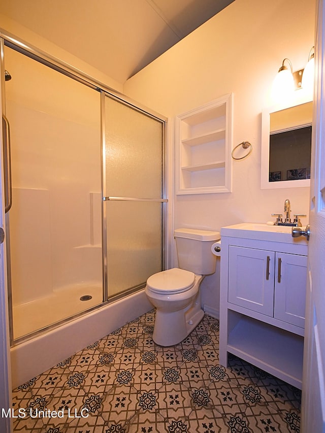 bathroom featuring an enclosed shower, toilet, vanity, and tile patterned floors