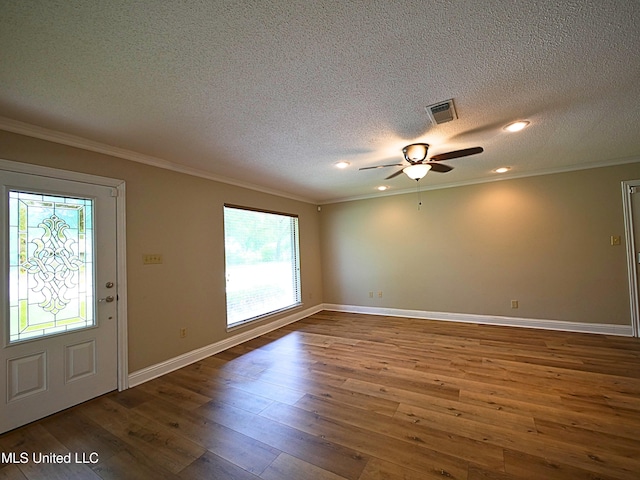 entryway featuring plenty of natural light, ornamental molding, a textured ceiling, hardwood / wood-style flooring, and ceiling fan
