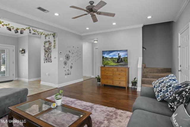 living area with visible vents, ornamental molding, wood finished floors, recessed lighting, and stairs