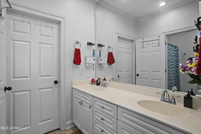 full bathroom with double vanity, ornamental molding, and a sink