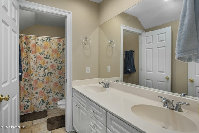 full bathroom with a sink, lofted ceiling, toilet, and tile patterned floors