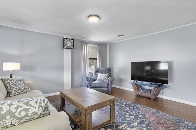 living room with crown molding and dark wood-type flooring