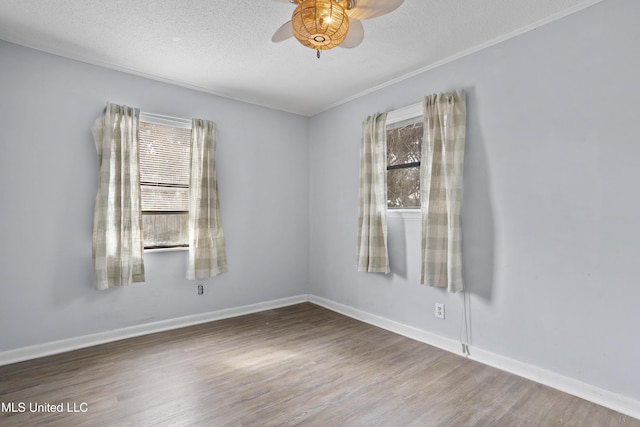 spare room with ceiling fan, wood-type flooring, and a textured ceiling