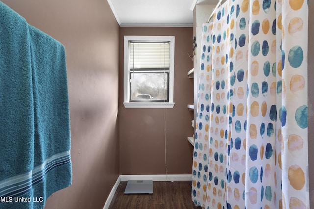 bathroom with crown molding, hardwood / wood-style floors, and walk in shower