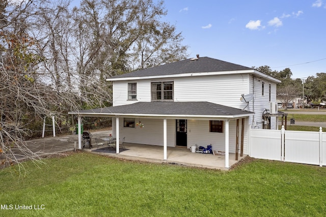 back of property featuring a yard and a patio area