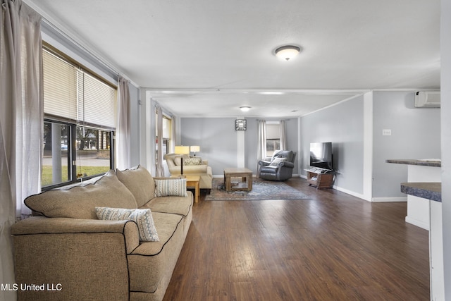 living room with dark wood-type flooring and an AC wall unit