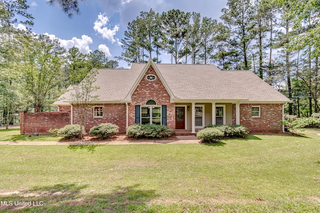 209 Lake Terrace Pl, Brandon, MS 39047 - view of front of house featuring brick siding, a front lawn, a shingled roof, and covered porch