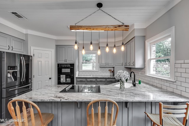 209 Lake Terrace Pl, Brandon, MS 39047 - kitchen with black appliances, gray cabinets, backsplash, and a peninsula