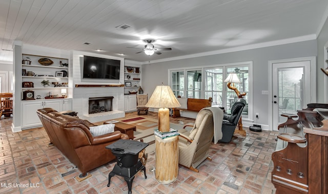209 Lake Terrace Pl, Brandon, MS 39047 - living room with ceiling fan, brick flooring, a brick fireplace, and crown molding