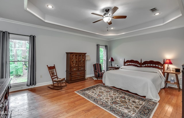 209 Lake Terrace Pl, Brandon, MS 39047 - bedroom featuring a raised ceiling, light wood finished floors, ceiling fan, recessed lighting, and crown molding