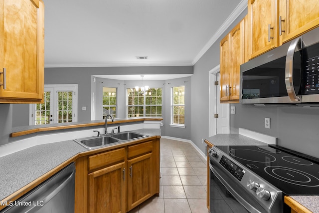 kitchen featuring light tile patterned floors, appliances with stainless steel finishes, a chandelier, crown molding, and sink