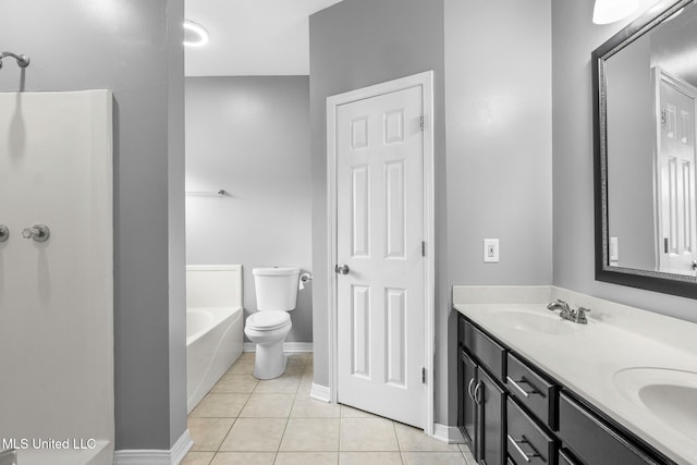 bathroom with toilet, a relaxing tiled tub, vanity, and tile patterned flooring